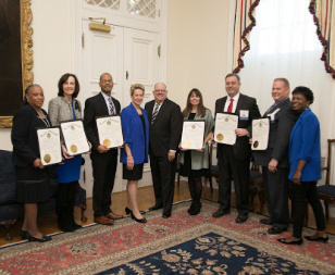 6 award winners holding certificates pose with Maryland Governor Larry Hogan and State Superintendent of Schools Dr. Karen B. Salmon