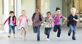   Group Of Elementary Age Schoolchildren Running Outside