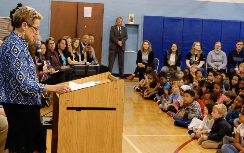 State Superintendent of Schools Dr. Karen B. Salmon speaks to elementary students from a podium in the school gym.