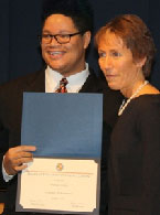 Michael F. receiving a certificate.