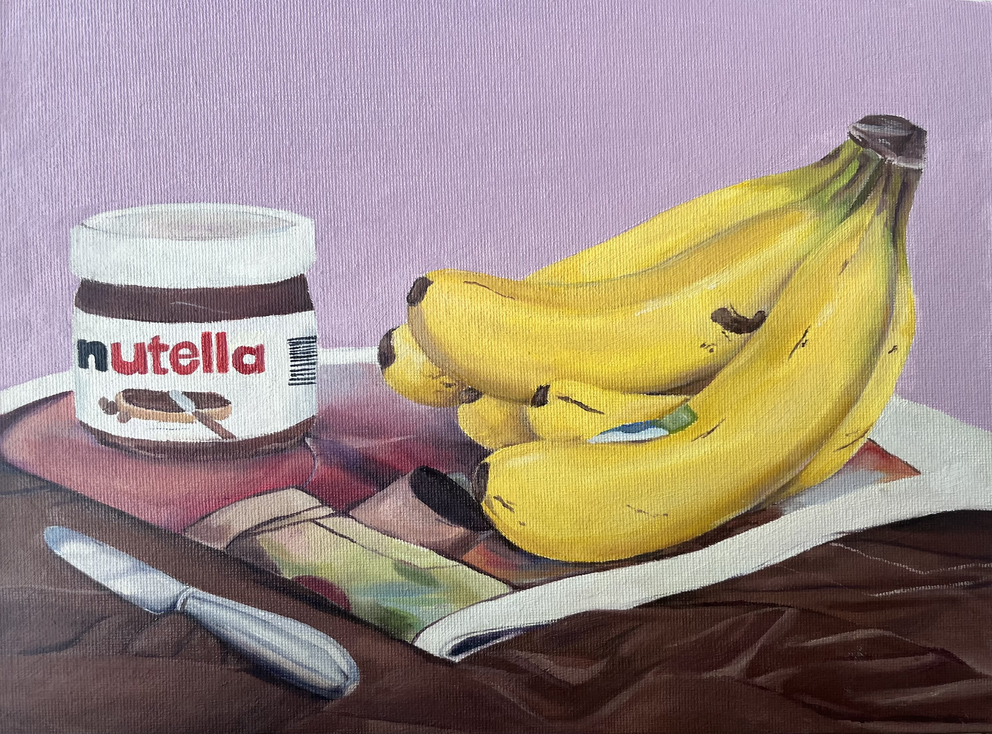 Titled, Banana Still Life, depicting a banana and a jar of Nutella, on top of a newspaper with a butter knife lying next to it; on top of a brown material surface and with a lavender background. Medium: Oil paint